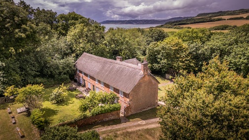 An aerial view of the St Gabriel's cottages and the coast, Dorset